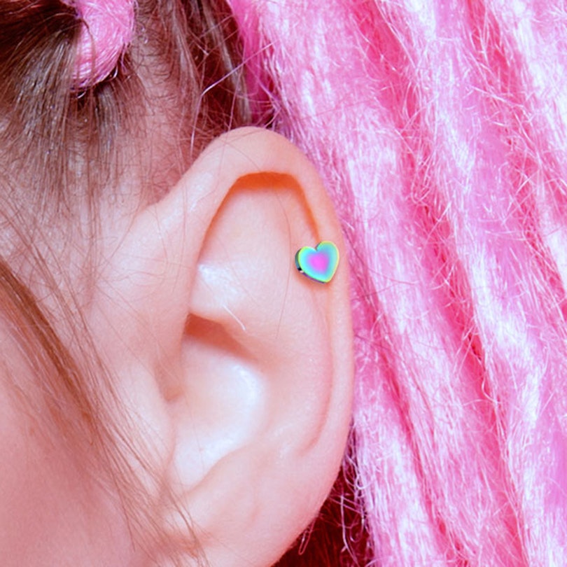 Ear piercing in different colors with design