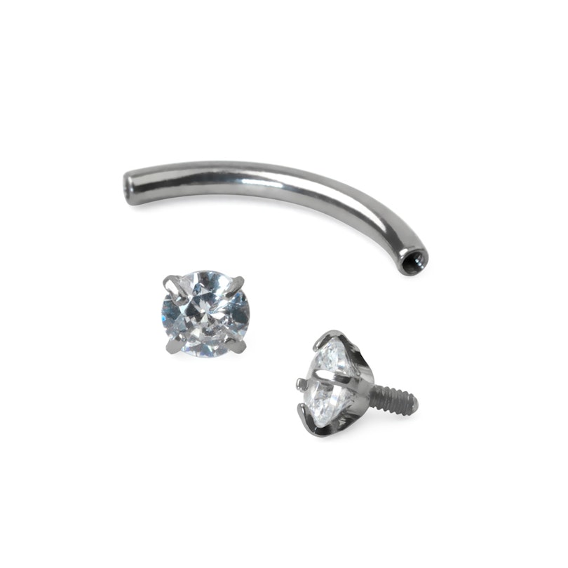 Curved barbell made of titanium with internally threaded gemstone ends