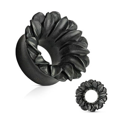 Tunnel in black organic wood as a flower