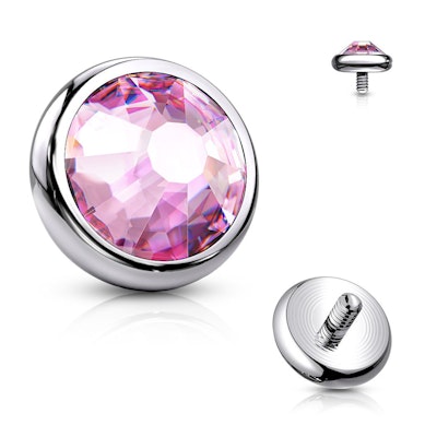 Dermal top jewelry made of titanium with colored stone.