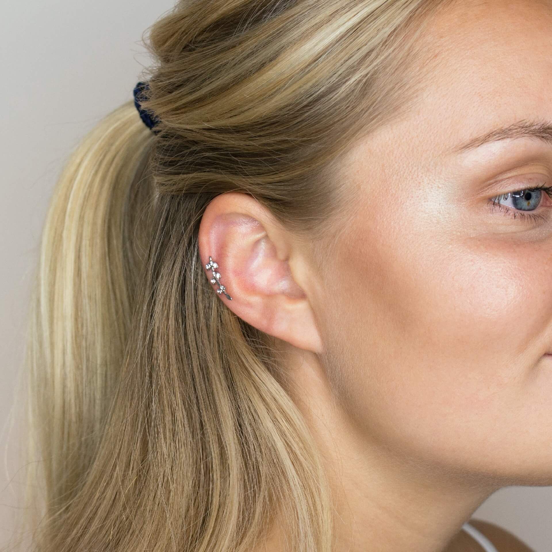 Ear piercing with studded leaves