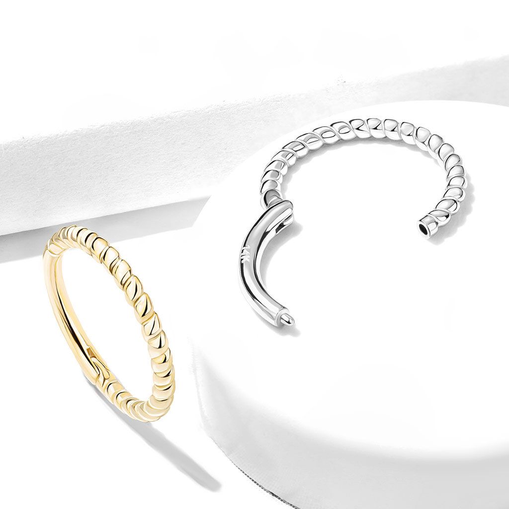 Hinged ring made of 14k gold with braided design