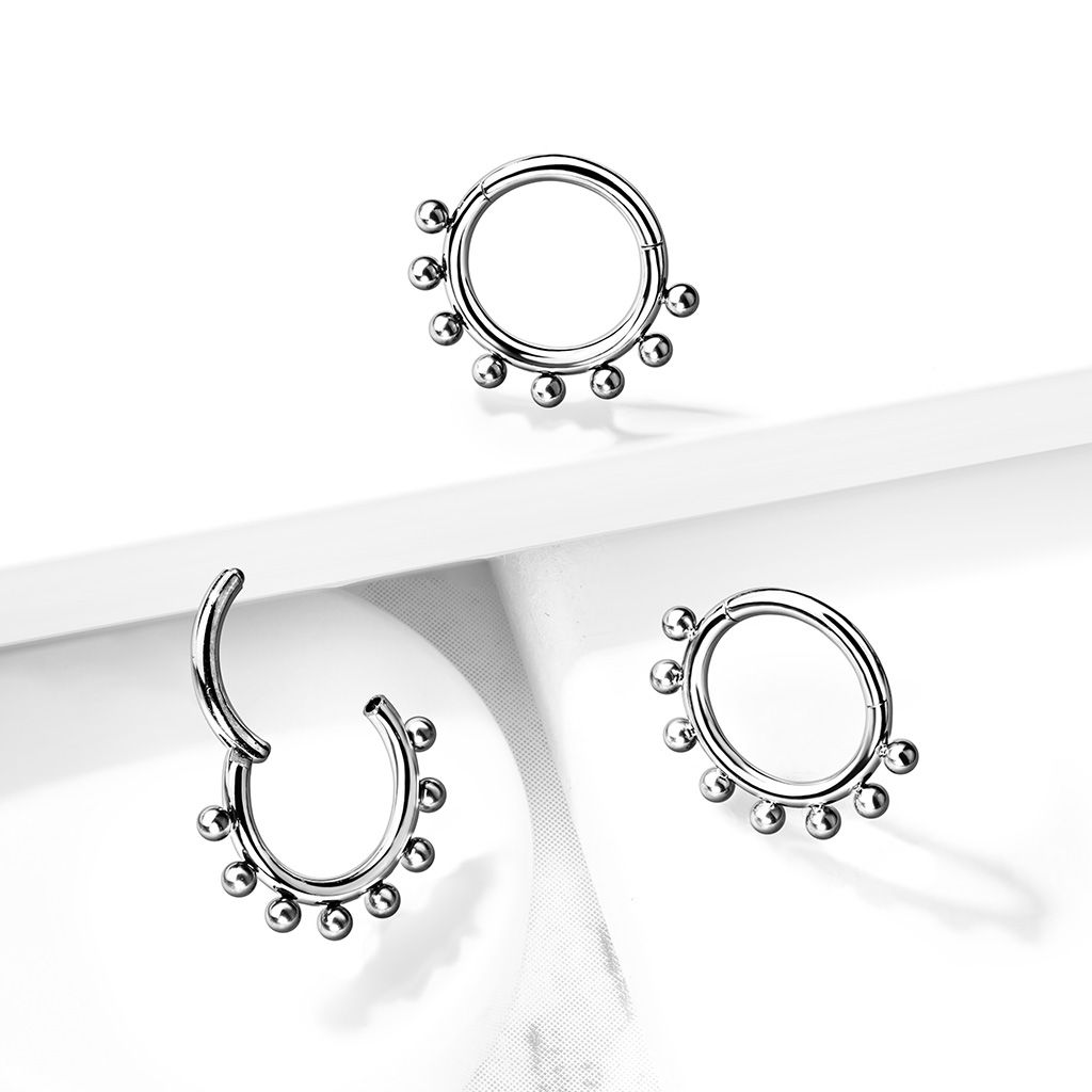 Ring made of titanium with a hinge and outer beads