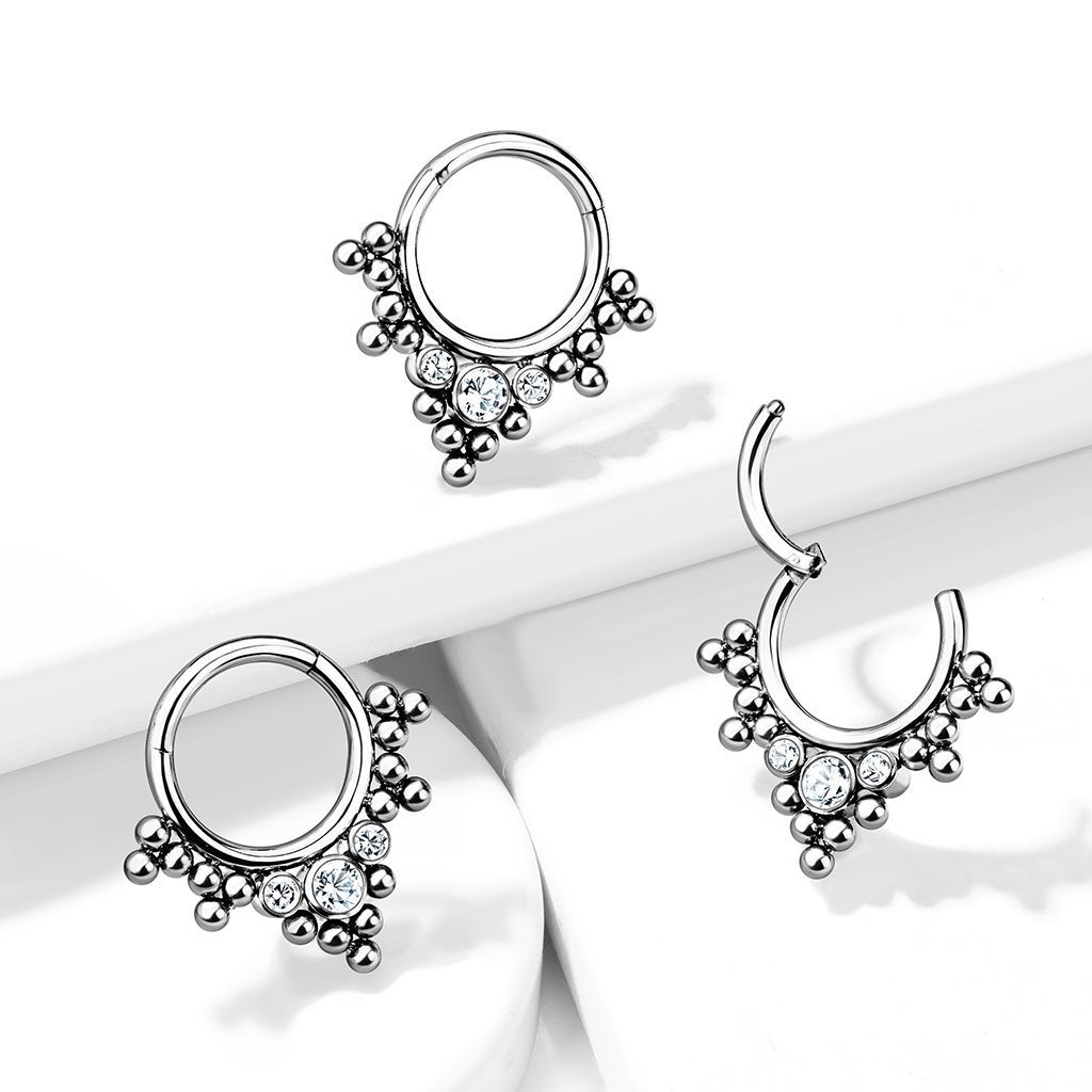 Hinged ring made of titanium with clustered beads and stones