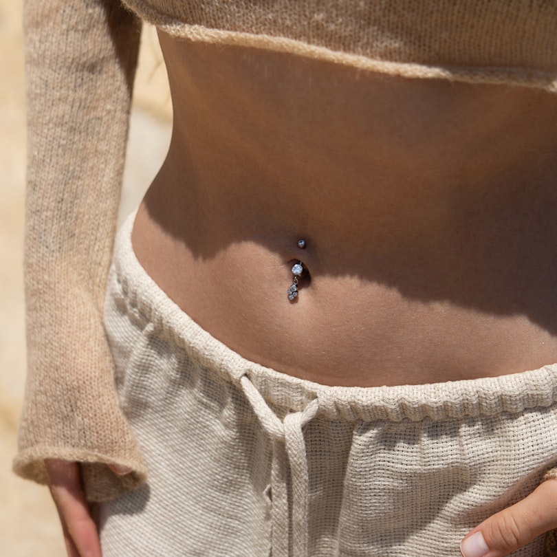 Belly button ring made of titanium with a dangling cluster of bezel-set stones Body Jewelry