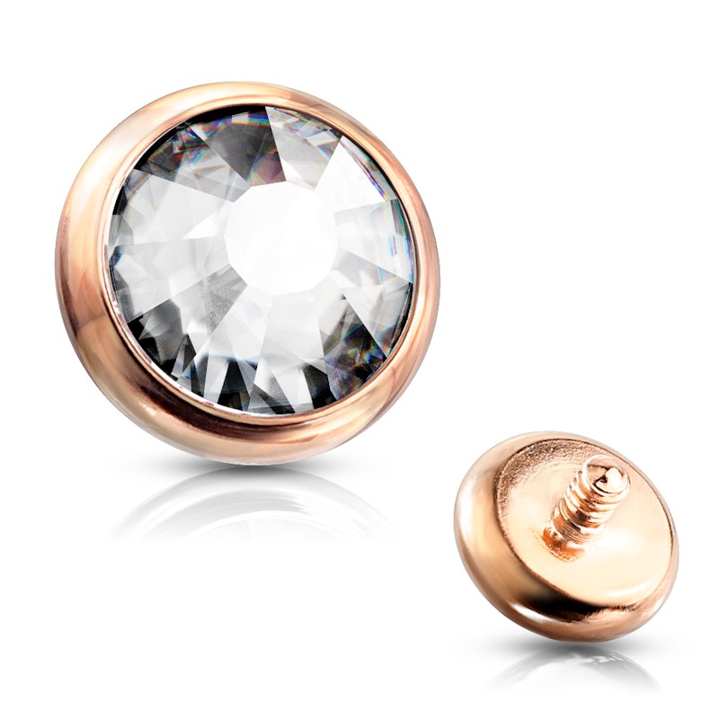 Dermal top jewelry in a variety of colors with crystal stone. Body Jewelry