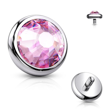Dermal top jewelry made of titanium with colored stone.