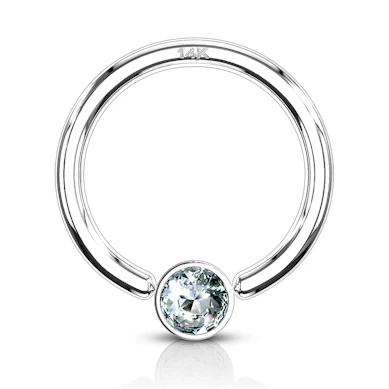 Captive bead ring made of 14k gold with bezel-set stone