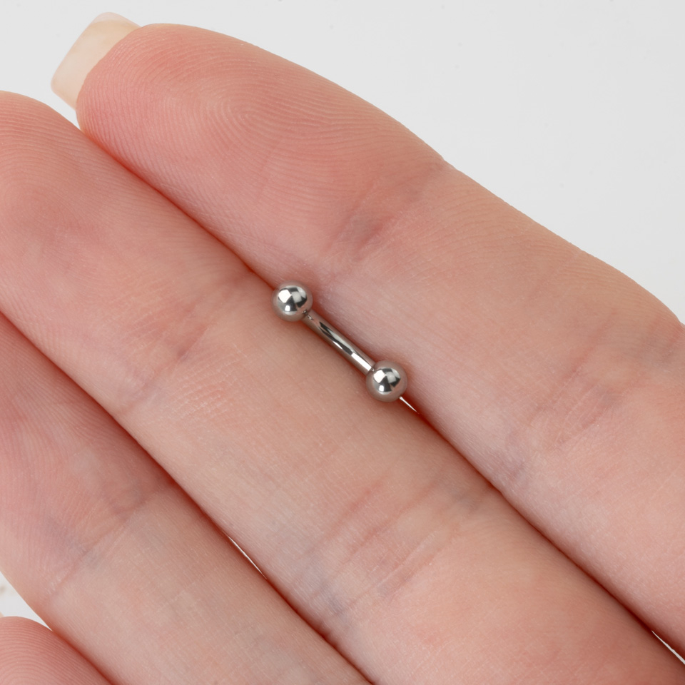 Curved barbell internally threaded made of titanium