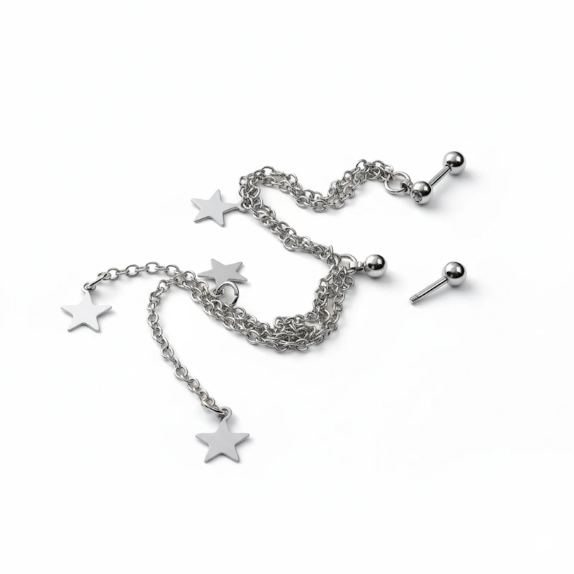 Tragus and helix piercing with stars and chains