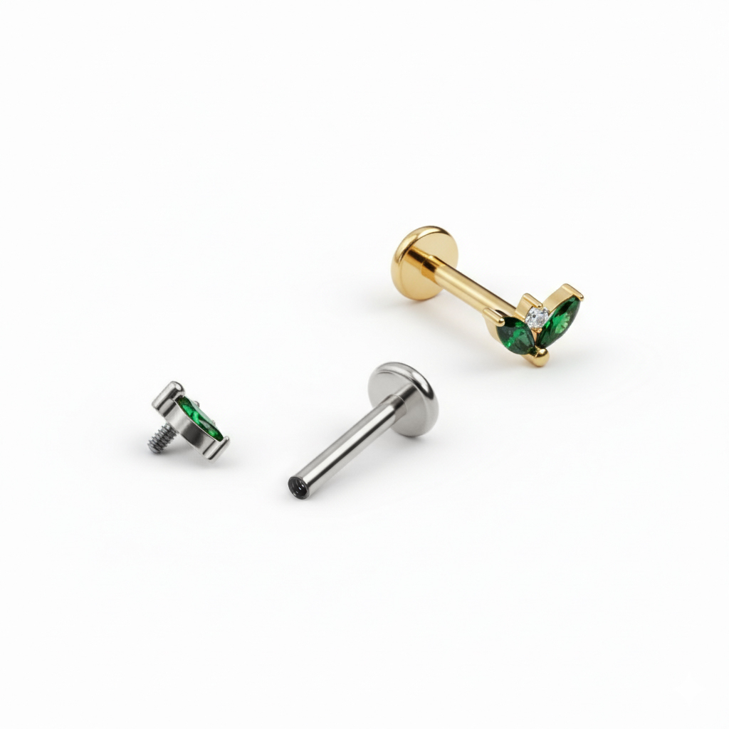 Titanium labret with pair of emerald colored stones