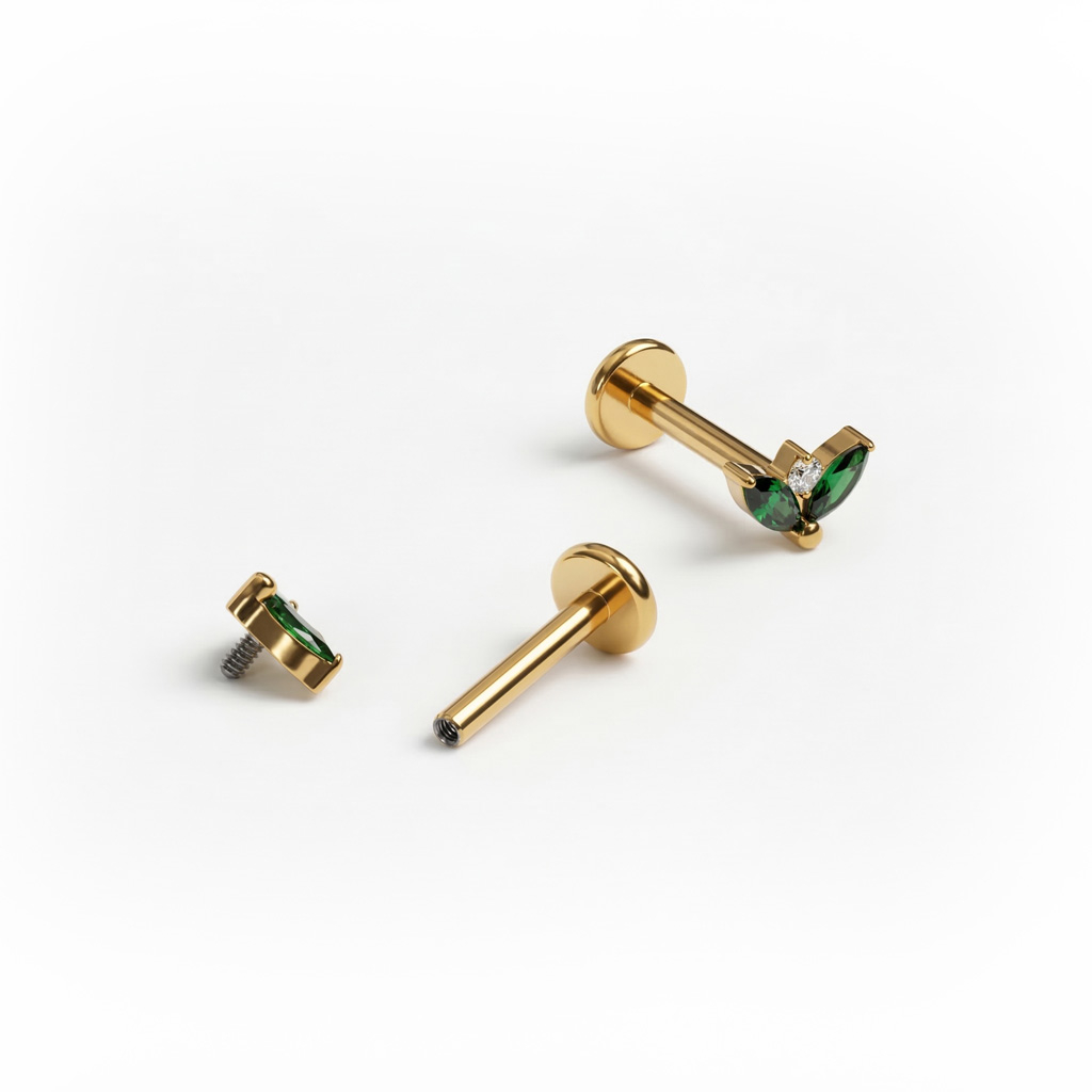 Titanium labret with pair of emerald colored stones