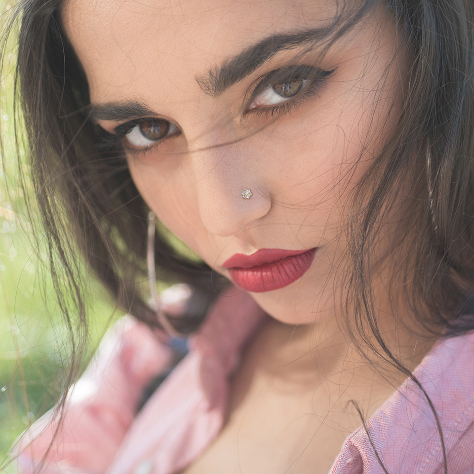 Nose ring made of 14k gold with studded flower