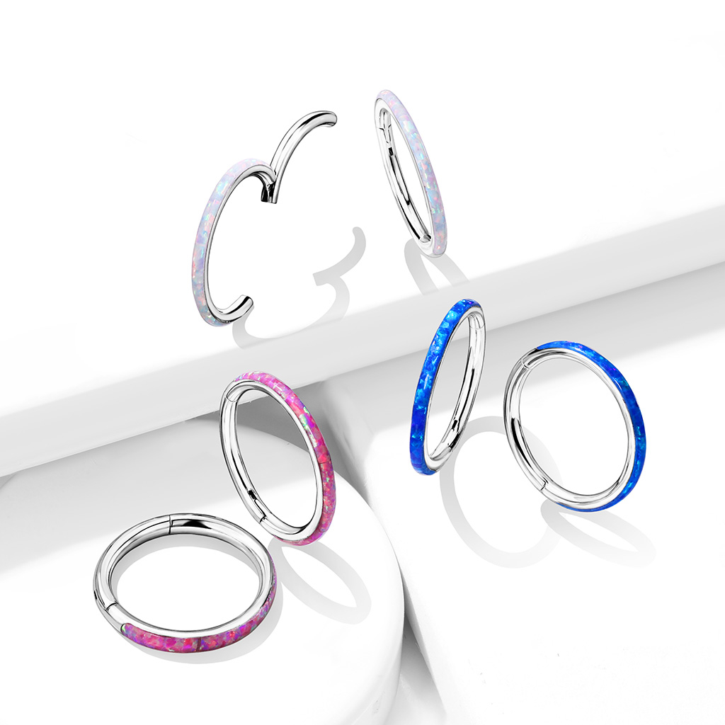 Ring made of titanium with a hinge and opal outer side