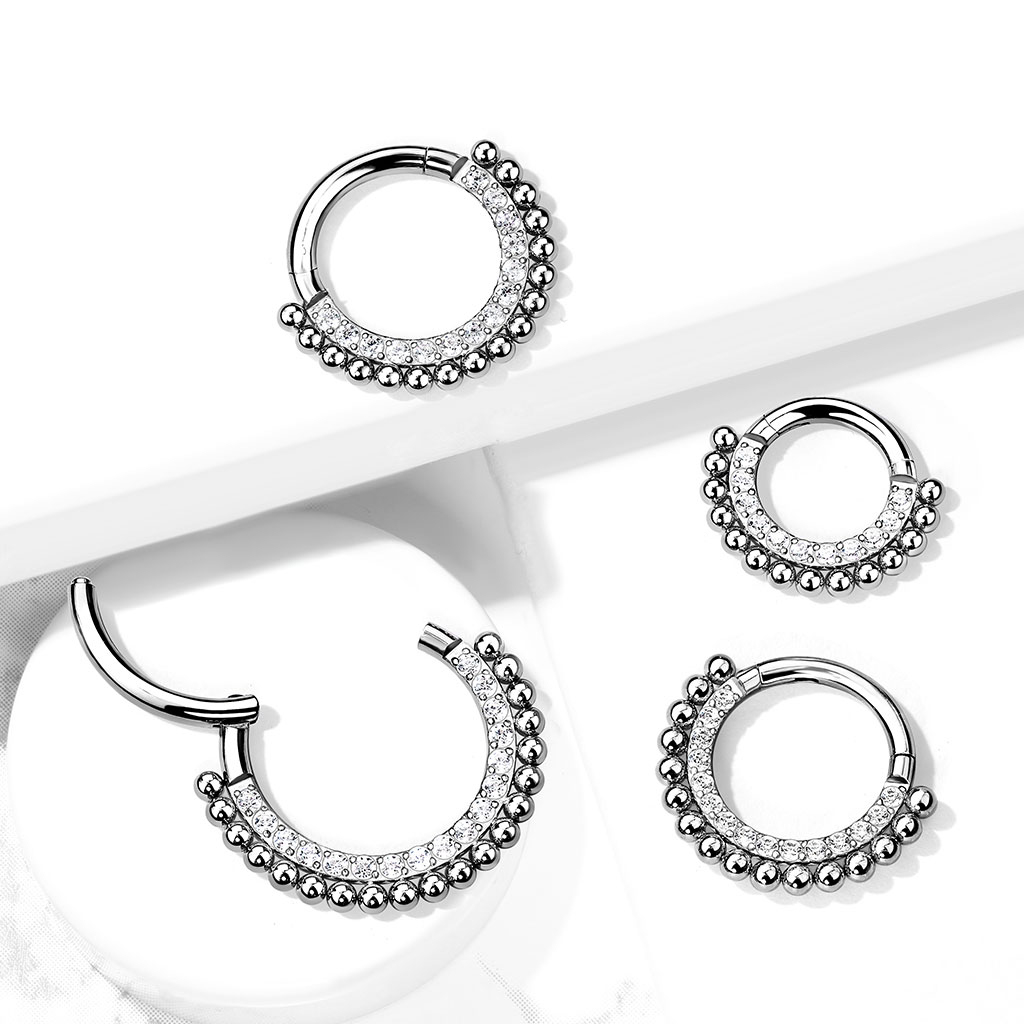 Hinged ring made of titanium with gemstones and small beads