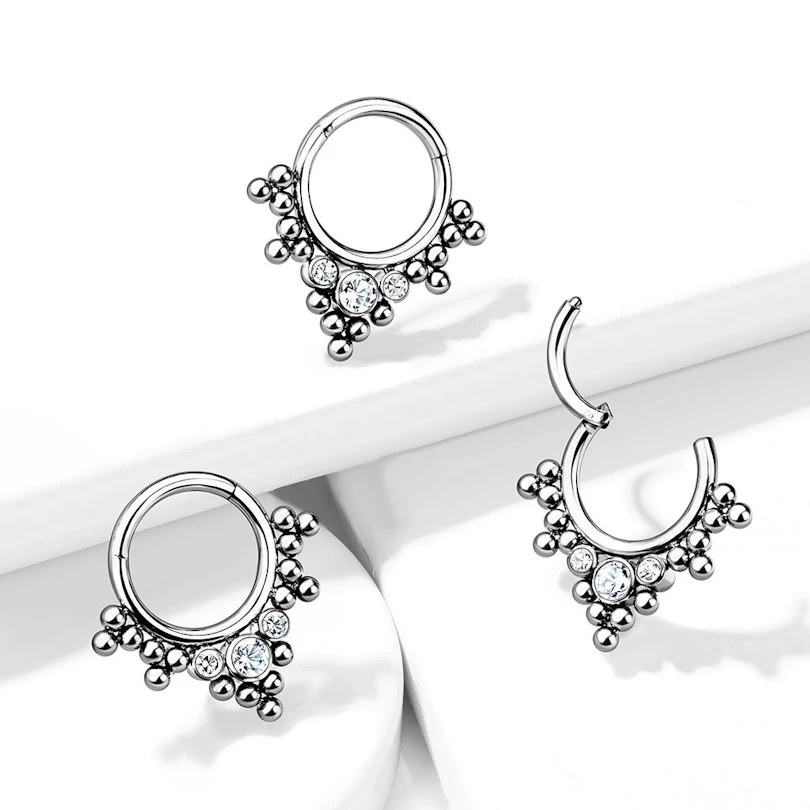 Hinged ring made of titanium with clustered beads and stones